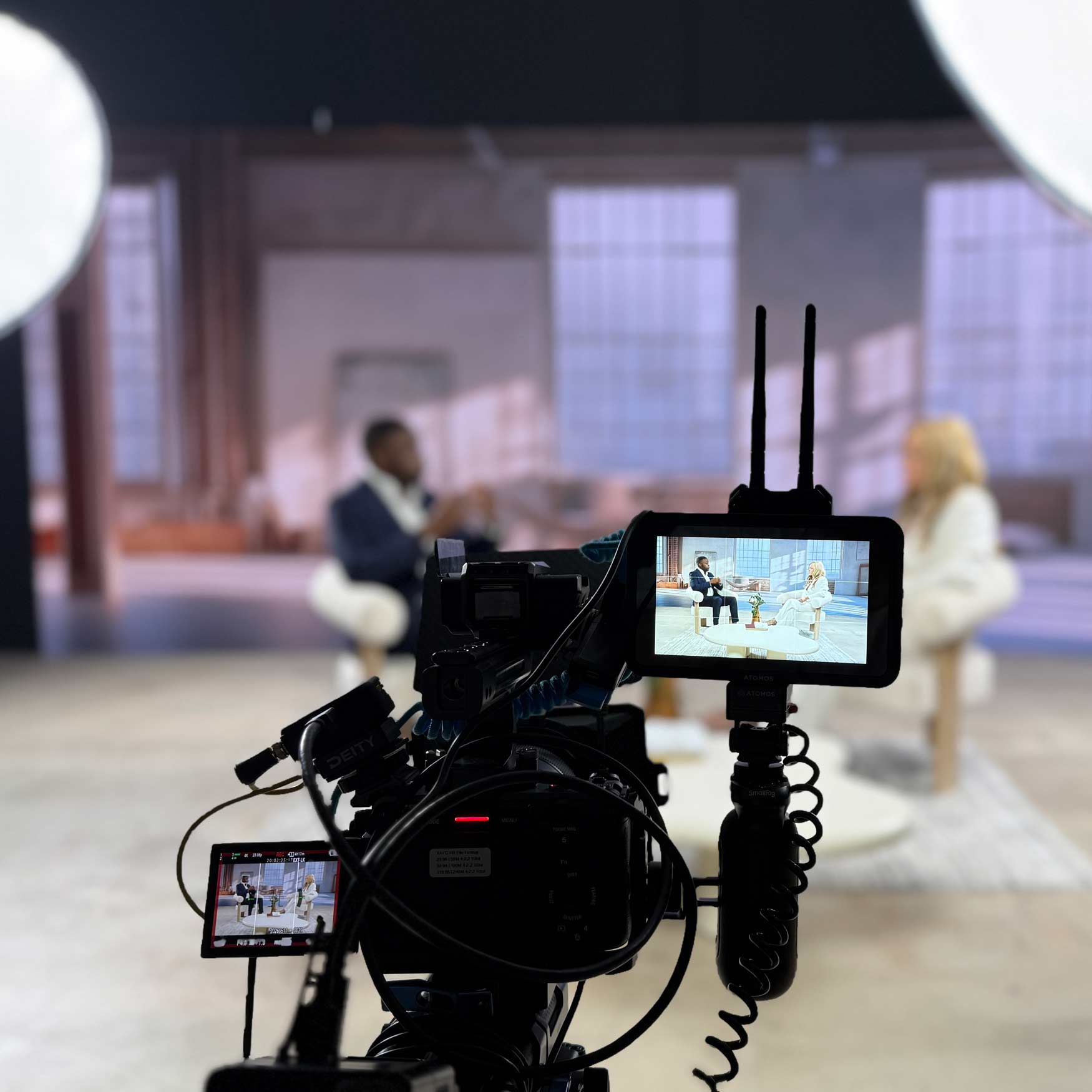 Camera monitor framing a two-person interview on set