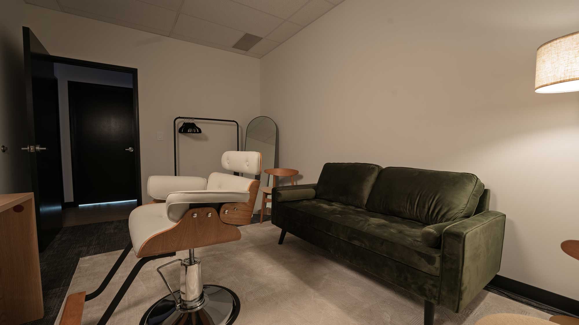 Makeup and styling room with vanity mirror and prep station