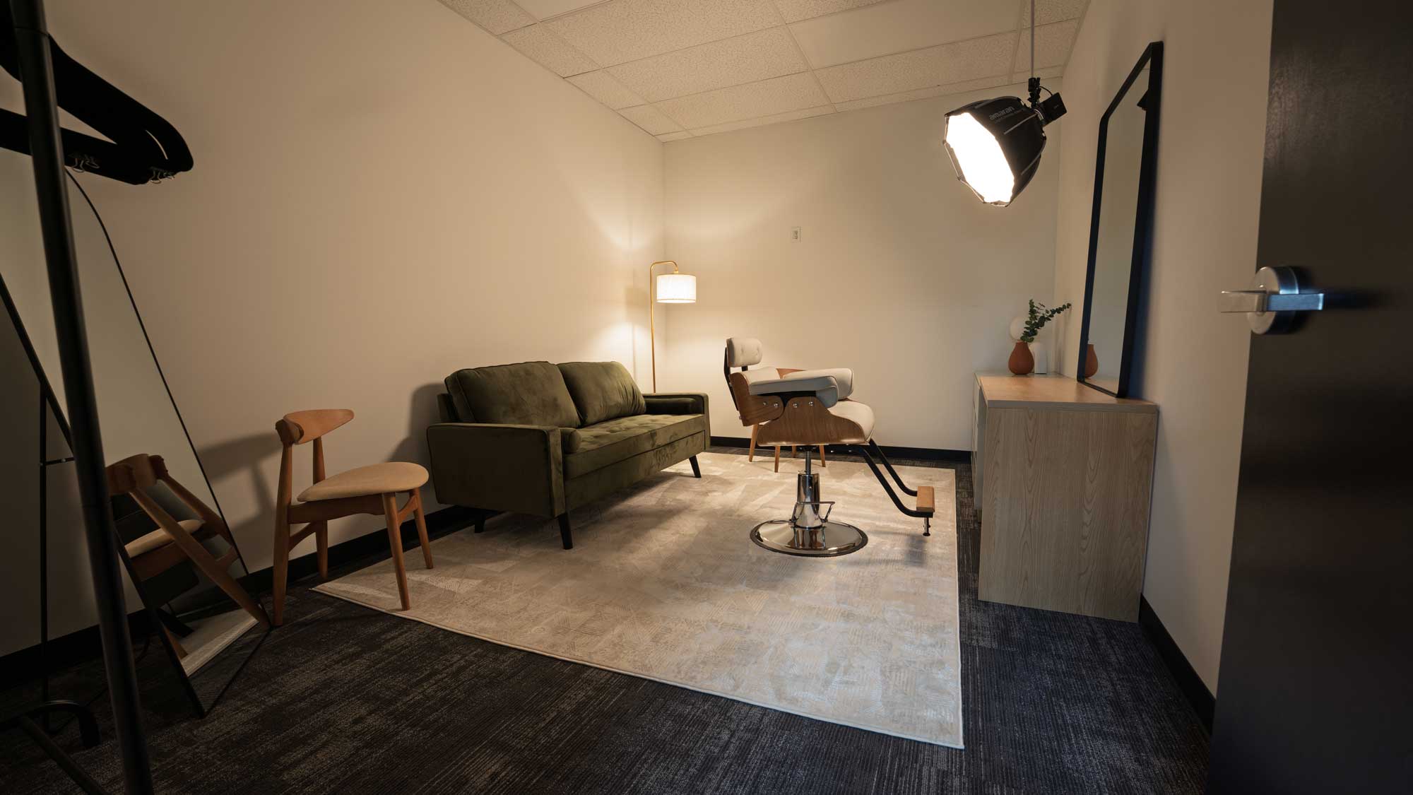 Shared common area with kitchenette and lounge seating