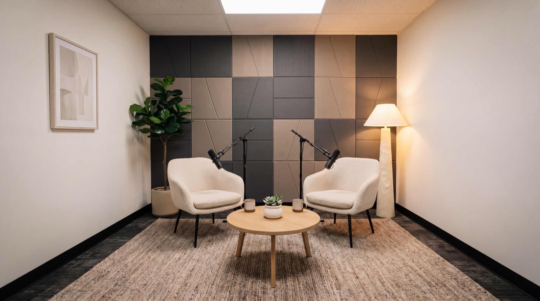 Medium Studio Suite layout — acoustic panel feature wall, two podcast chairs, broadcast mics